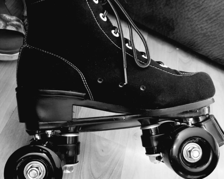 black and white photo of an adult-size leather roller skate