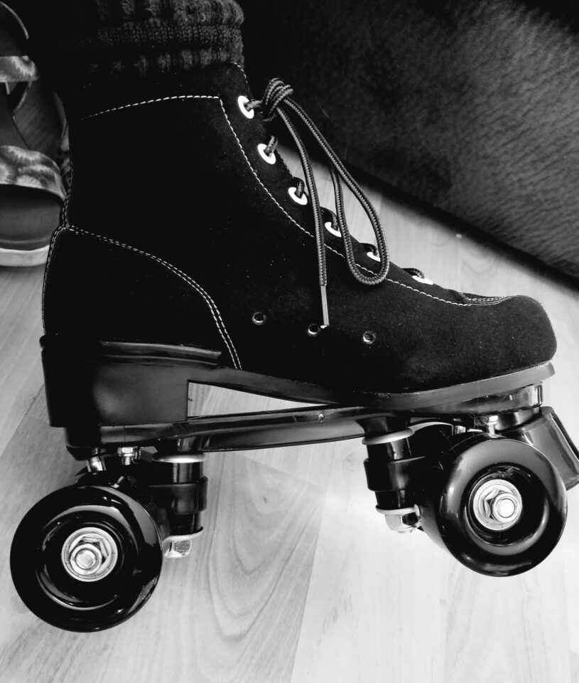 black and white photo of an adult-size leather roller skate