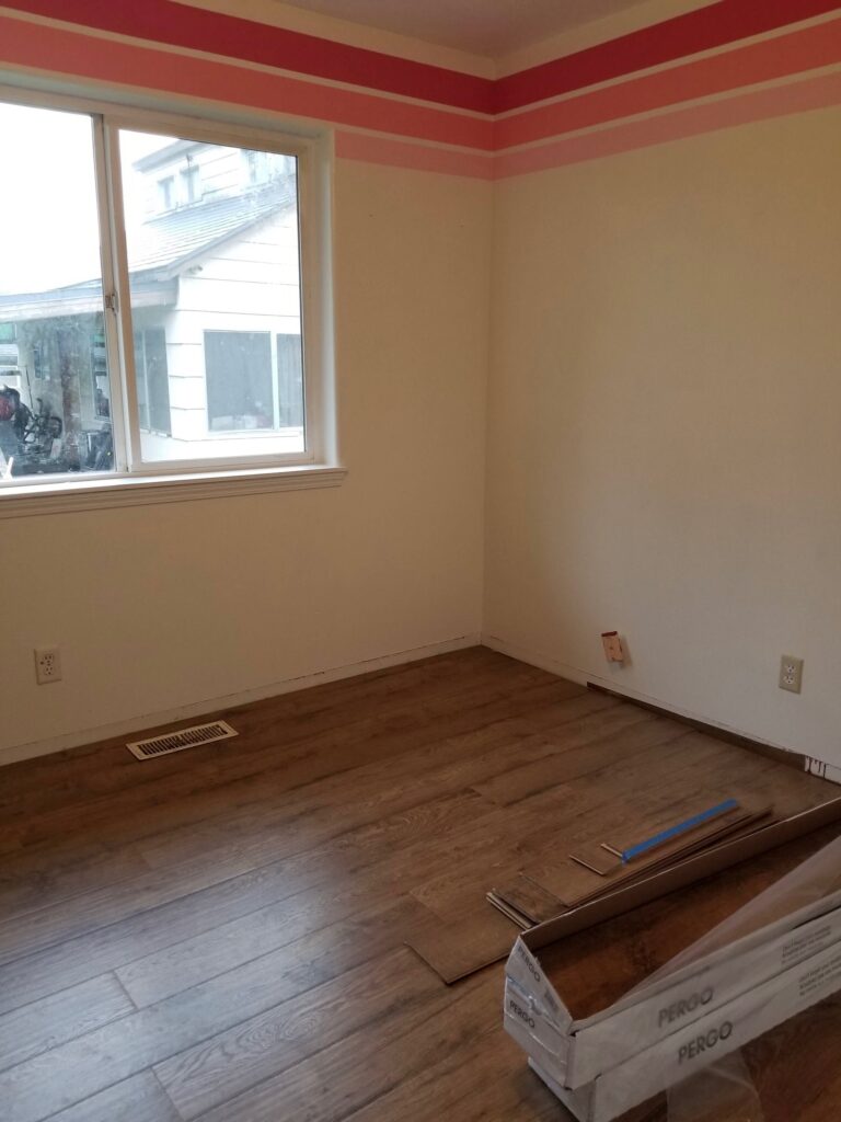 newly installed laminate in the kids room with pink stripes