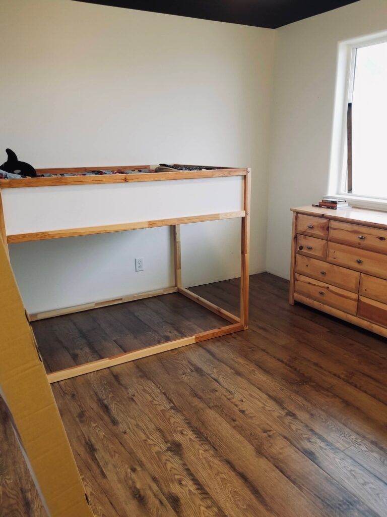 finished laminate floors in kids room with dark blue constellation ceiling