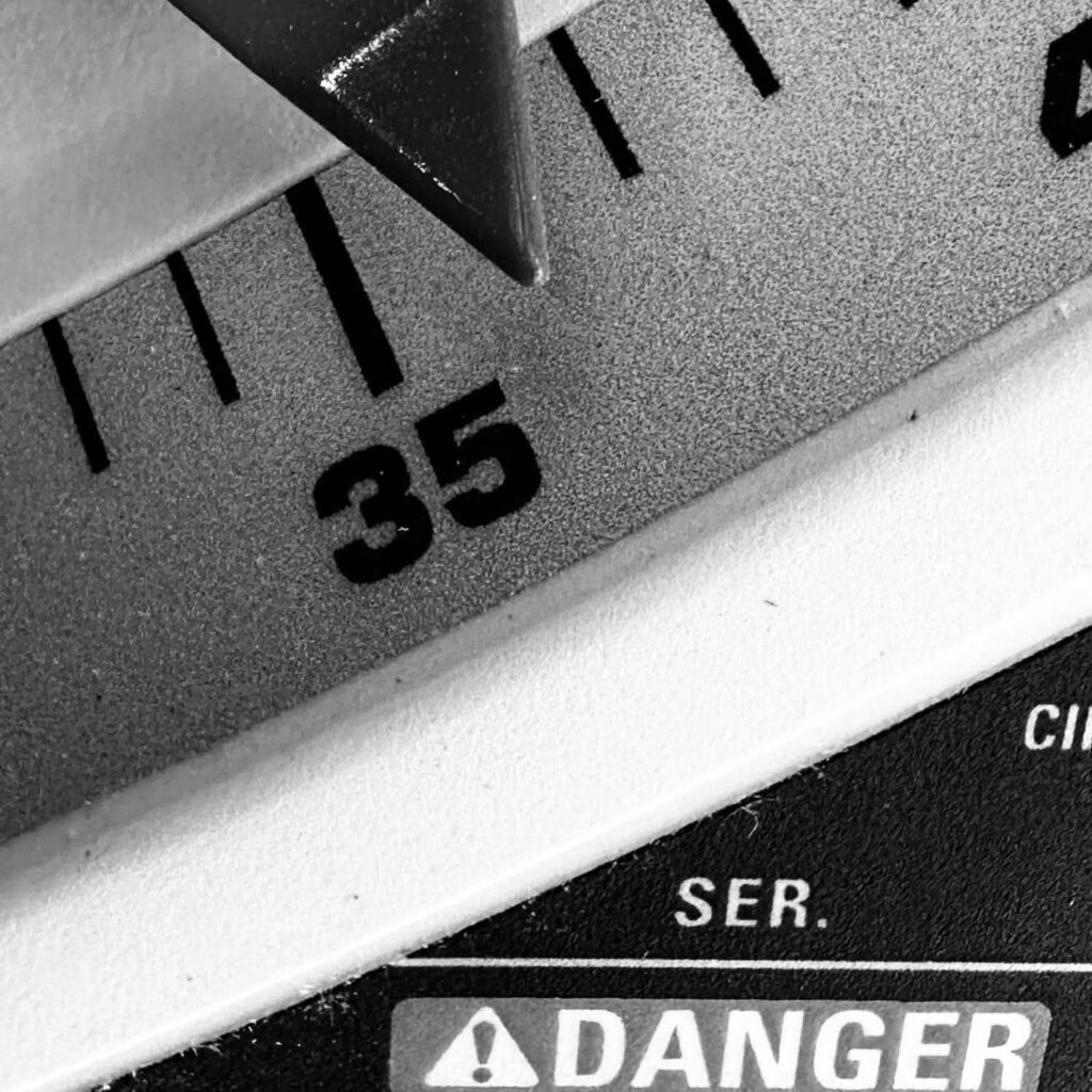 Black and white close-up of angle 36 on a Duwalt 10-inch table saw blade. She was Out of My League.