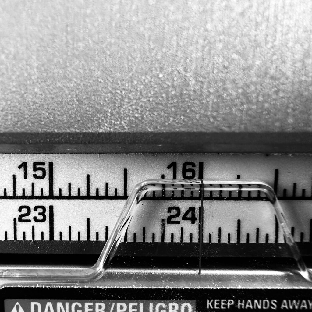 Black and white close-up of 24-inch mark on a Duwalt 10-inch table saw fence placement. She was Out of My League.