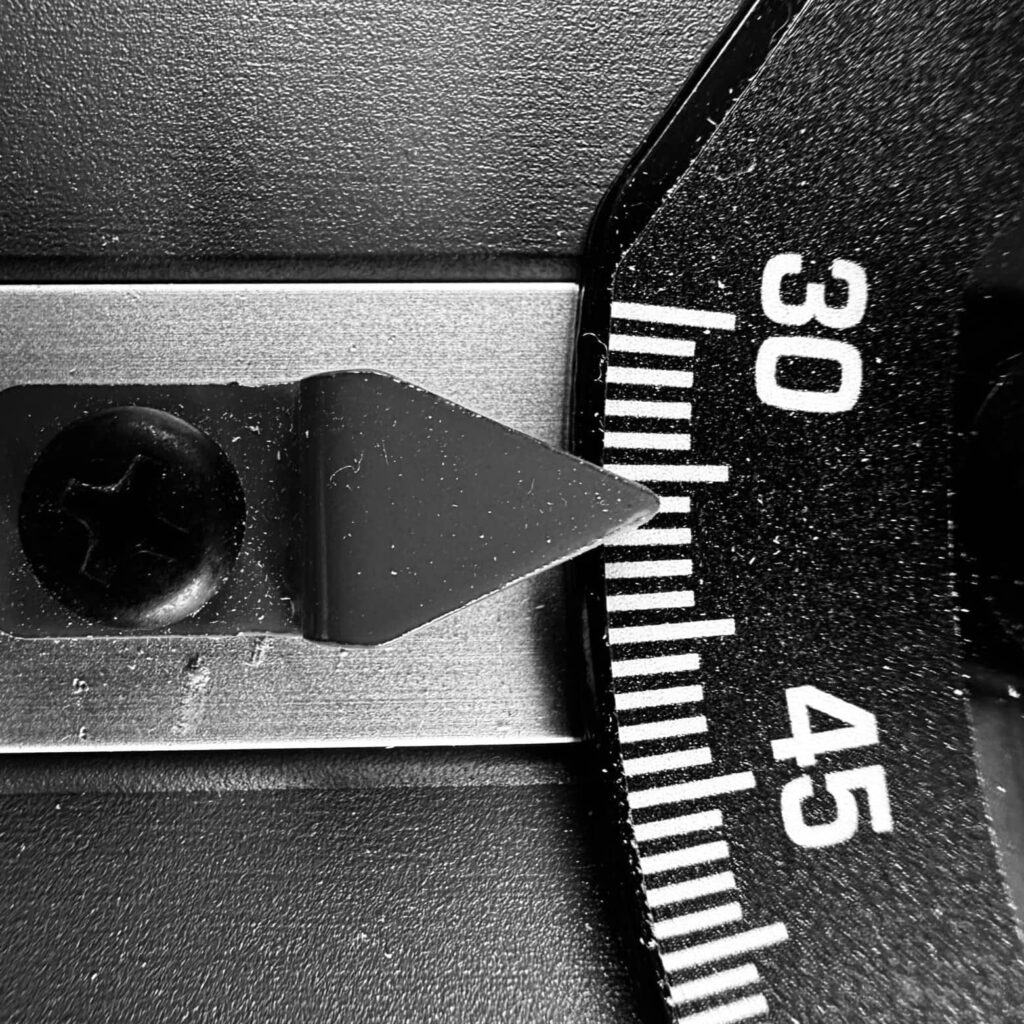 Black and white close-up of angle 36 on a Duwalt 10-inch table saw miter gauge. She was Out of My League.