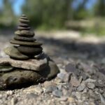A stack of balanced river rocks placed by Sue Evergreen in a post about removing rocks for mindfulness