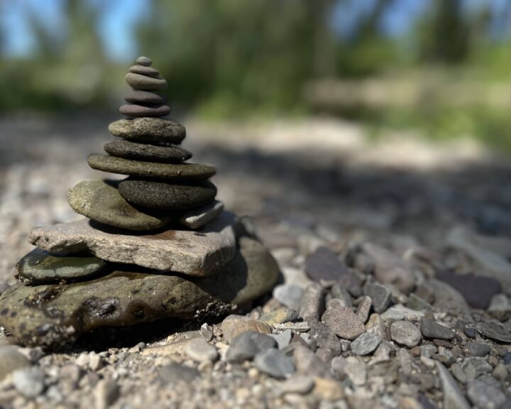 A stack of balanced river rocks placed by Sue Evergreen in a post about removing rocks for mindfulness