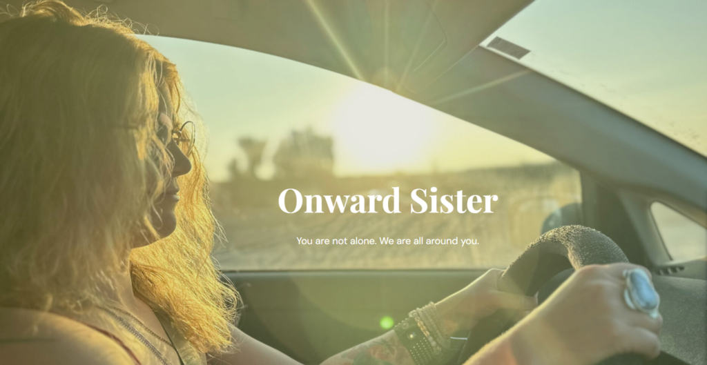 A photo of a woman driving a car with the sun setting out the driver's-side window, casting a warm glow over her. The photo is the banner for the Onward Sister homepage and is copyrighted by Onward Sister.